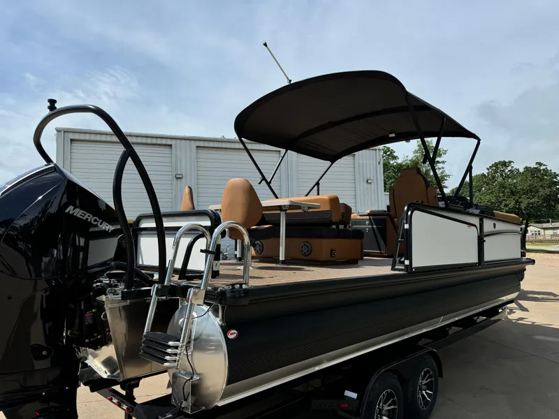 Slide: The Image of 2025 Premier 250 Sunsation Rear Social pontoon boat with canopy and Mercury engine. - 12