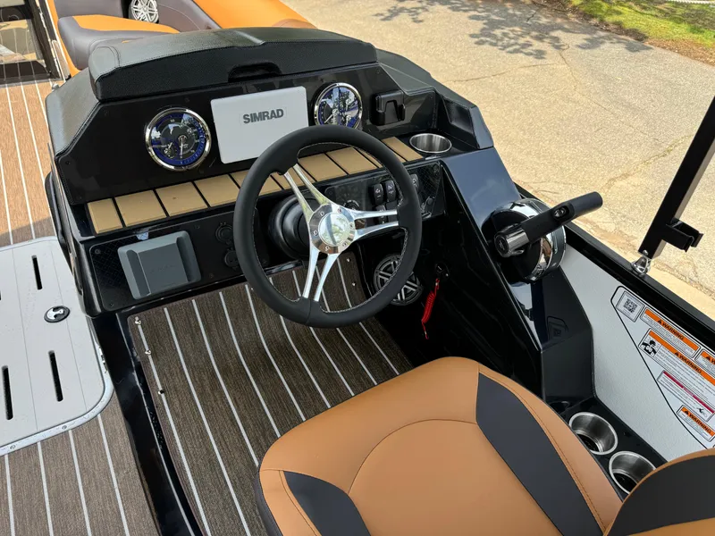 Slide: The Image of 2025 Premier 250 Sunsation Rear Social boat dashboard with steering wheel and controls. - 19