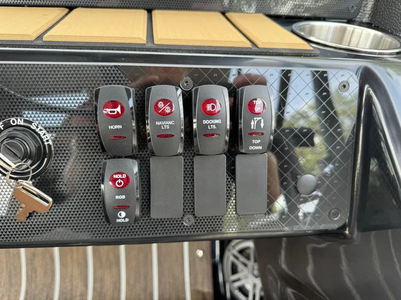 Slide: The Image of Control panel of 2025 Premier 250 Sunsation Rear Social boat with switches and key ignition. - 20