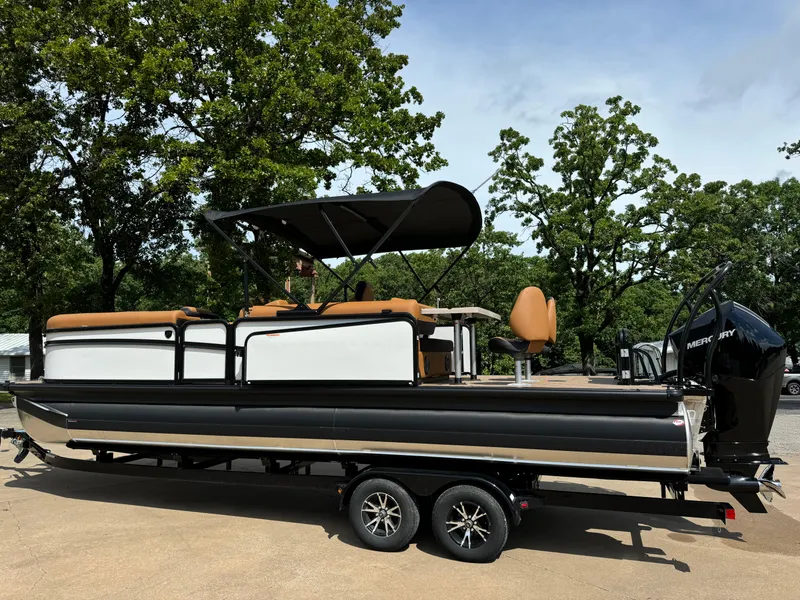 Slide: The Image of 2025 Premier 250 Sunsation Rear Social pontoon boat on trailer, parked outdoors. - 4