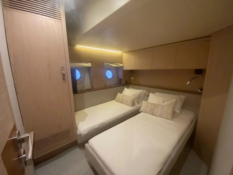 Slide: The Image of 2017 Beneteau Monte Carlo MC6 cabin with twin beds and modern wood finish. - 38