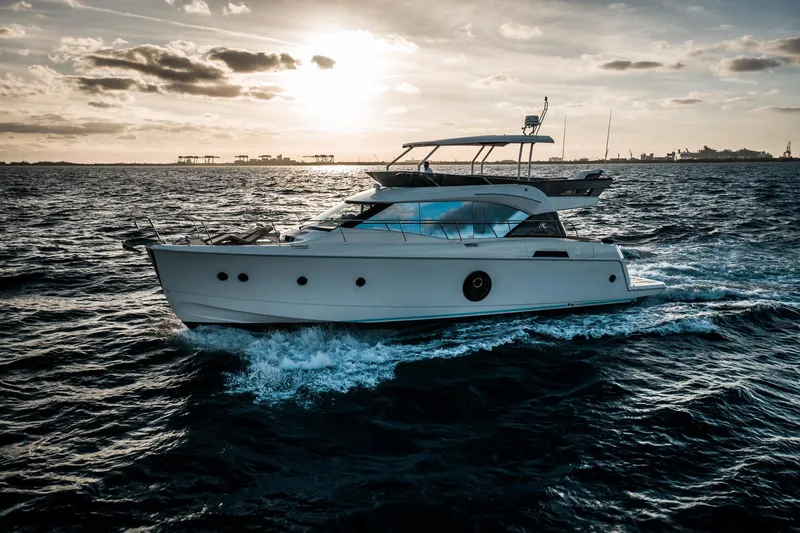 Slide: The Image of 2017 Beneteau Monte Carlo MC6 yacht cruising at sunset on open water. - 7