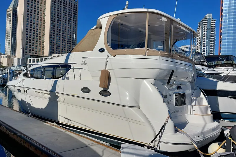 The Image of 2004 Sea Ray 390 Motor Yacht docked in a marina with cityscape background. - 0