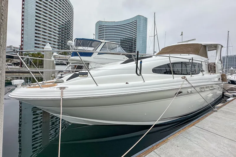 Slide: The Image of 2004 Sea Ray 390 Motor Yacht docked at marina, clear blue sky background. - 1