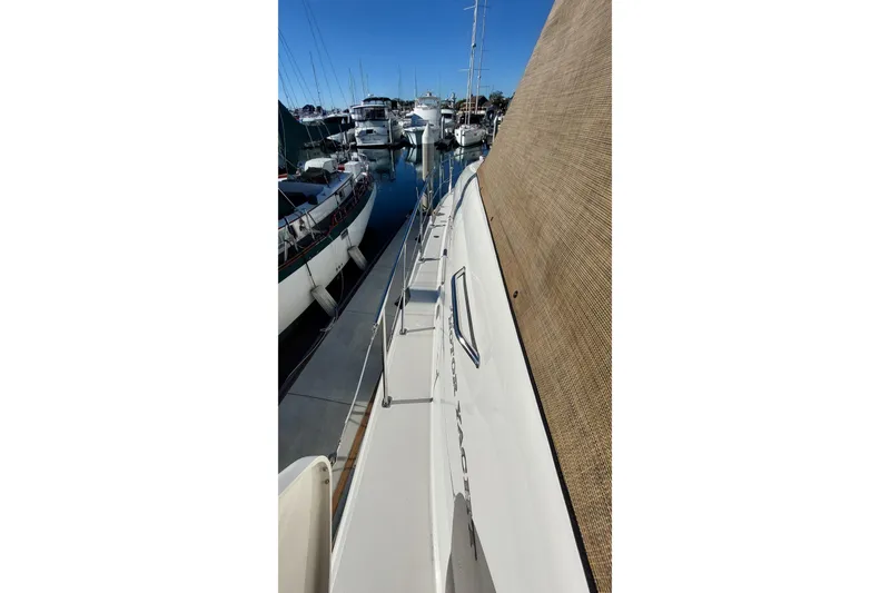 Slide: The Image of 2004 Sea Ray 390 Motor Yacht docked at marina, side view. - 10