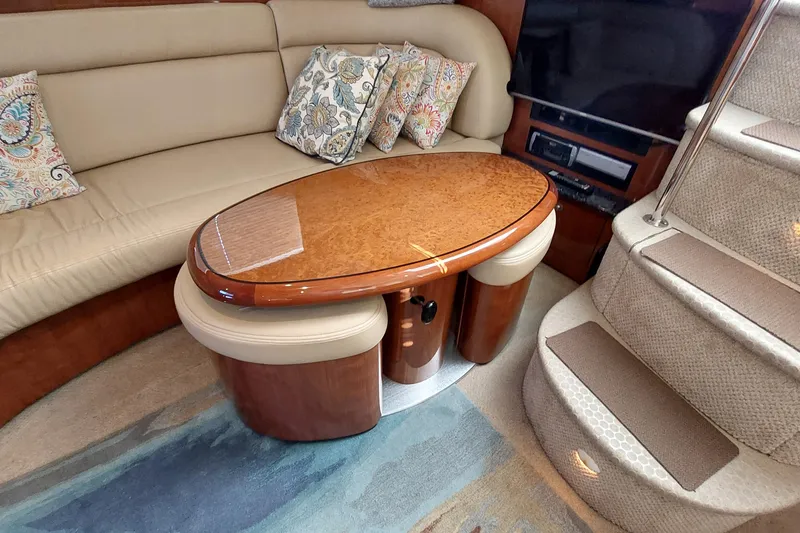 Slide: The Image of Luxurious interior of 2004 Sea Ray 390 Motor Yacht with elegant seating and wooden table. - 13