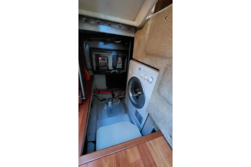 Slide: The Image of Laundry area inside 2004 Sea Ray 390 Motor Yacht, featuring a compact washing machine. - 17
