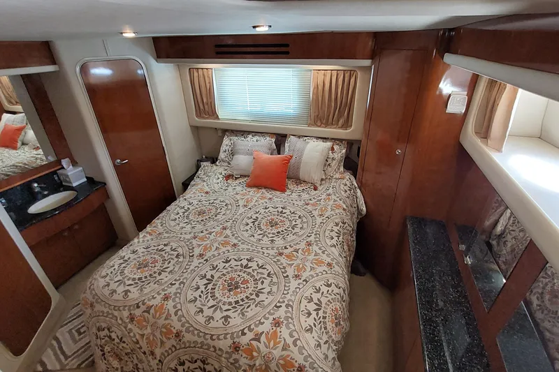 Slide: The Image of Luxurious 2004 Sea Ray 390 Motor Yacht bedroom with elegant bedding and wood finishes. - 19
