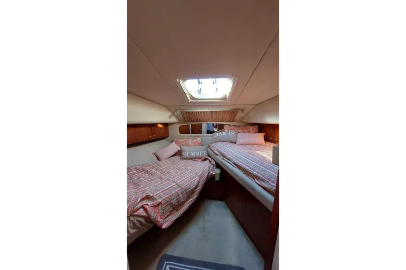 Slide: The Image of 2004 Sea Ray 390 Motor Yacht cabin with twin beds and skylight. - 21