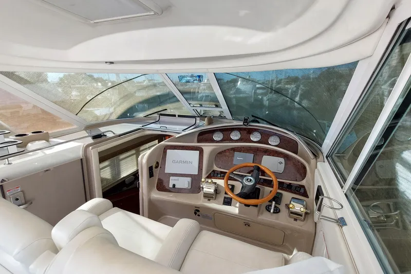 Slide: The Image of 2004 Sea Ray 390 Motor Yacht helm with Garmin navigation and luxurious interior. - 24