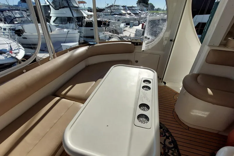 Slide: The Image of Interior of 2004 Sea Ray 390 Motor Yacht with seating and table, docked at marina. - 29
