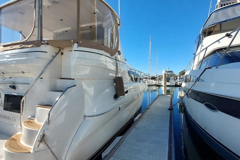 Slide: The Image of 2004 Sea Ray 390 Motor Yacht docked in a marina under clear blue skies. - 4