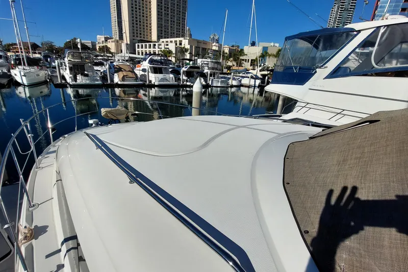 Slide: The Image of 2004 Sea Ray 390 Motor Yacht docked in a marina with cityscape background. - 6