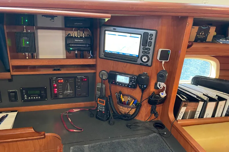 Slide: The Image of Navigation and communication equipment in a 2010 Hunter 49 Aft Cockpit sailboat cabin. - 14