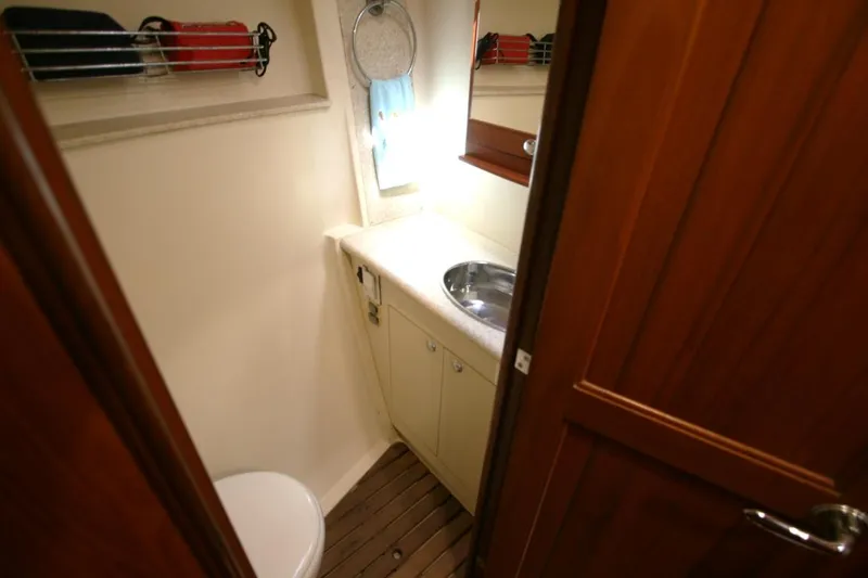 Slide: The Image of Compact bathroom in 2010 Hunter 49 Aft Cockpit yacht with sink and toilet. - 20