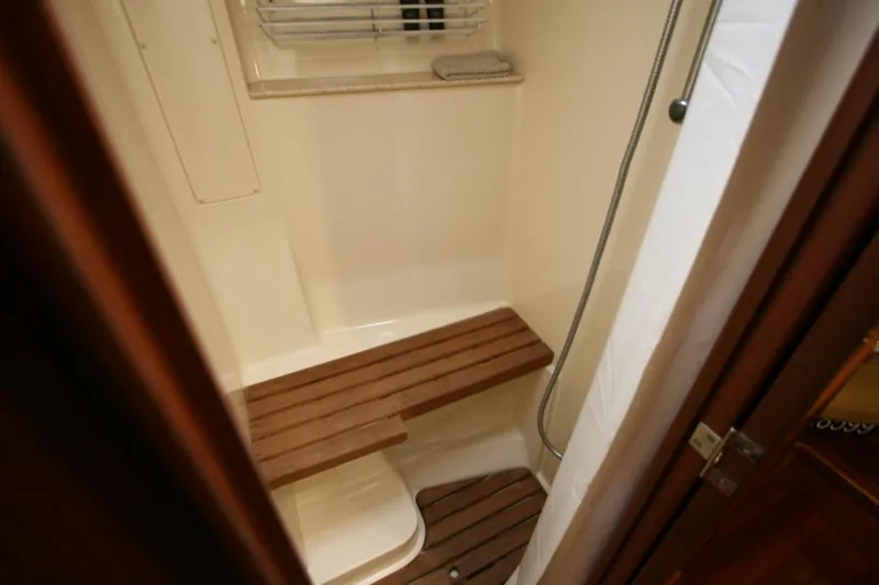 Slide: The Image of 2010 Hunter 49 Aft Cockpit shower with wooden bench and window. - 21