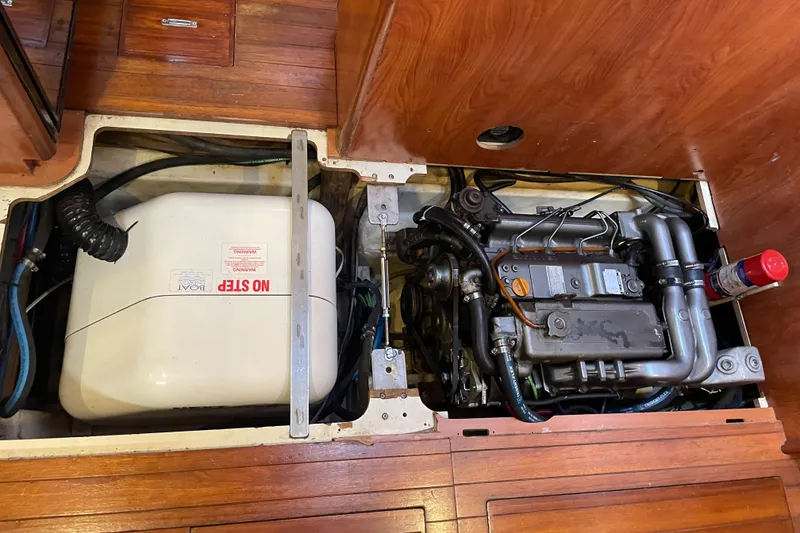 Slide: The Image of Engine compartment of 2010 Hunter 49 Aft Cockpit sailboat, featuring mechanical components and storage. - 27