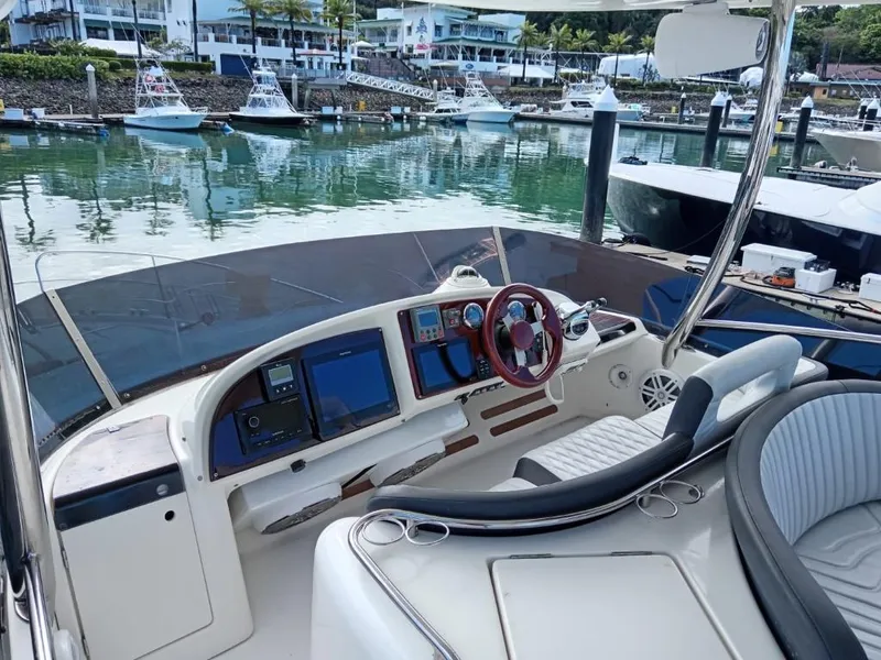 Slide: The Image of Cockpit of a 2006 Prestige 46 yacht docked in a marina. - 13