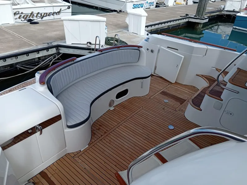 Slide: The Image of Luxury 2006 Prestige 46 yacht with elegant teak deck and curved seating at marina. - 19