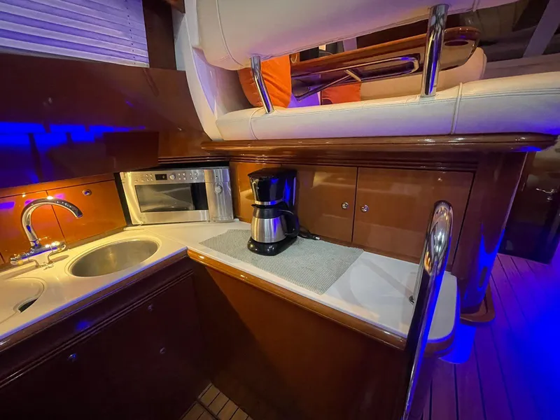 Slide: The Image of Luxurious 2006 Prestige 46 yacht kitchen with sink, microwave, and coffee maker. - 2