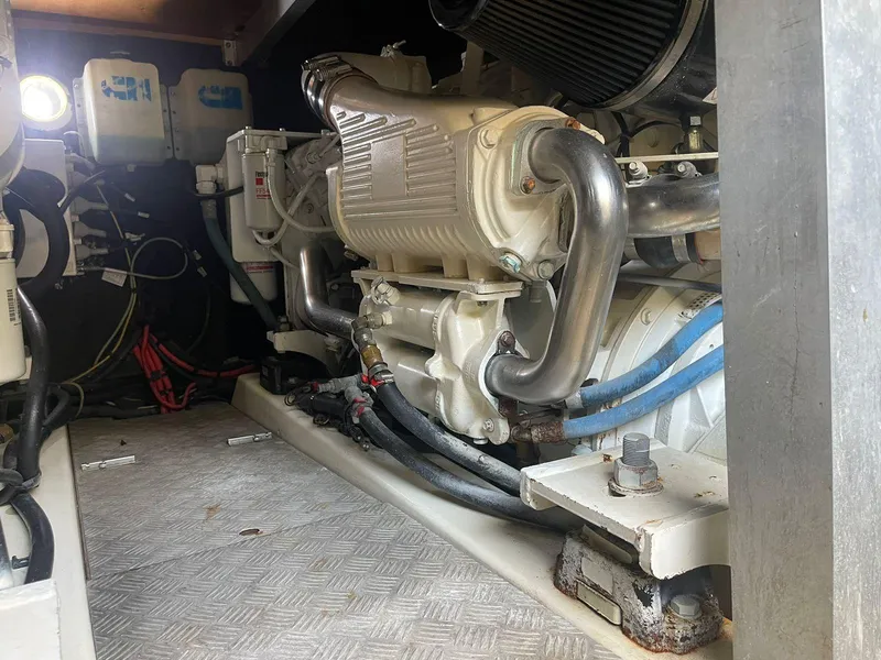 Slide: The Image of Engine room of a 2006 Prestige 46 yacht, showcasing mechanical components and piping. - 22