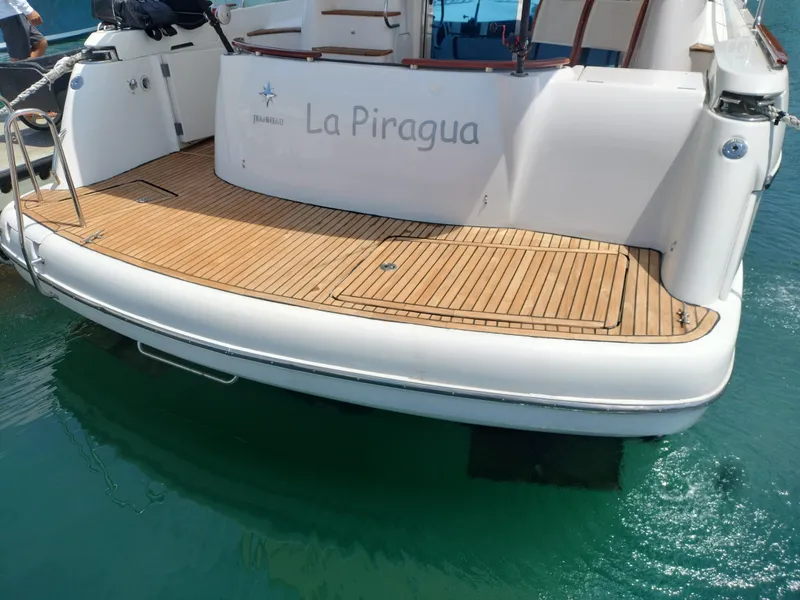 Slide: The Image of Stern view of 2006 Prestige 46 yacht named "La Piragua" with teak deck. - 23