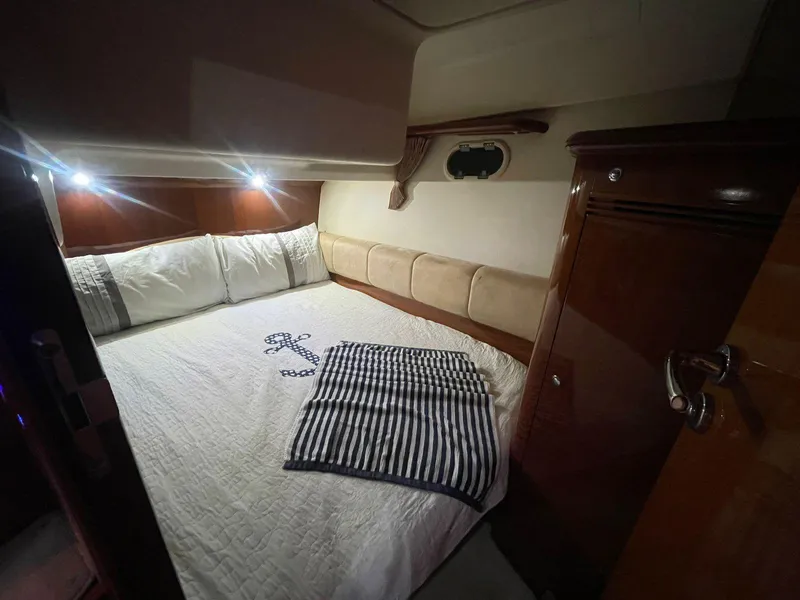 Slide: The Image of Cozy bedroom interior of a 2006 Prestige 46 yacht with elegant bedding and wood accents. - 6