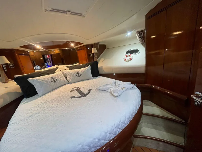 Slide: The Image of Luxurious cabin interior of a 2006 Prestige 46 yacht with nautical-themed bedding. - 9