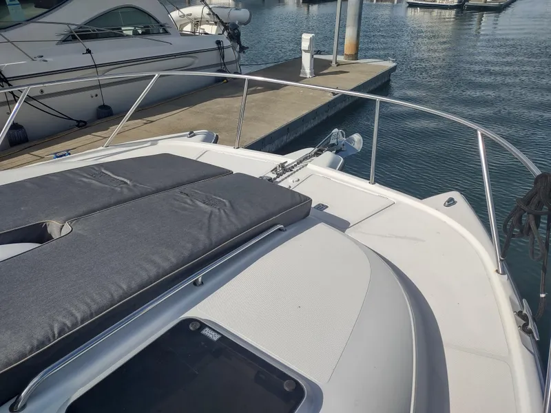 Slide: The Image of 2005 Glacier Bay 3490 Ocean Runner boat docked at marina, featuring spacious deck. - 14