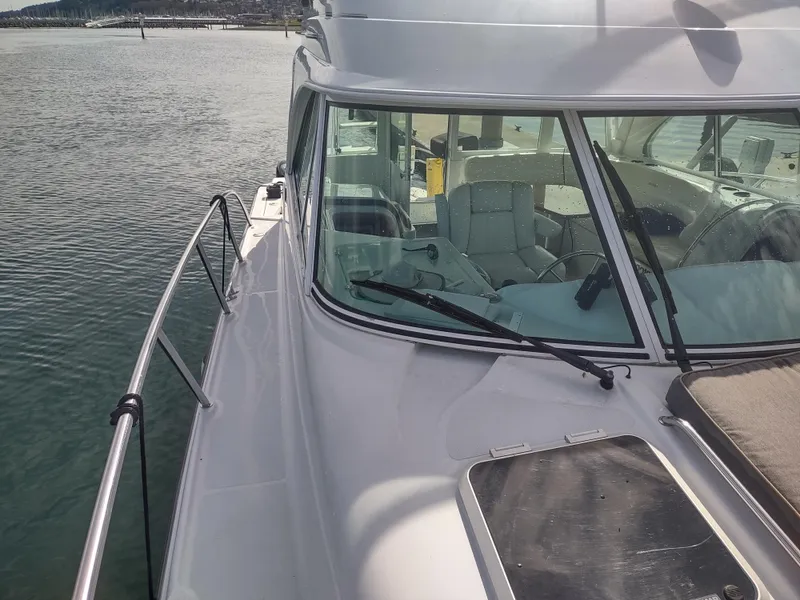 Slide: The Image of 2005 Glacier Bay 3490 Ocean Runner boat on calm water, side view of cabin and deck. - 17