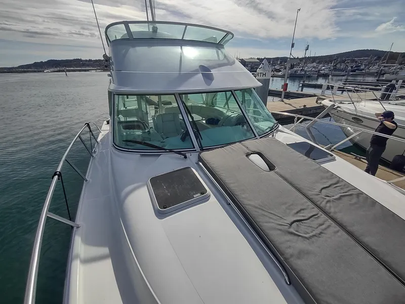 Slide: The Image of 2005 Glacier Bay 3490 Ocean Runner boat docked at marina under cloudy sky. - 19