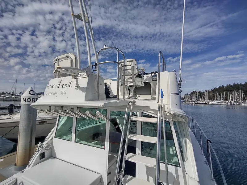 Slide: The Image of 2005 Glacier Bay 3490 Ocean Runner boat docked at marina under cloudy sky. - 25