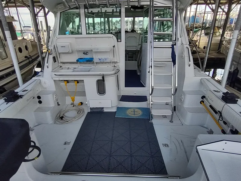 Slide: The Image of 2005 Glacier Bay 3490 Ocean Runner boat interior with fishing equipment and seating area. - 35