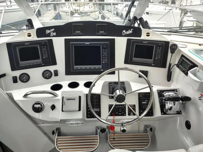 Slide: The Image of Helm of 2005 Glacier Bay 3490 Ocean Runner with navigation instruments and steering wheel. - 47