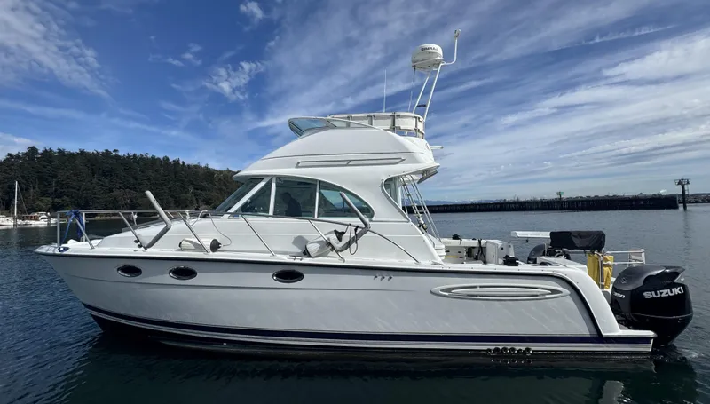 Slide: The Image of 2005 Glacier Bay 3490 Ocean Runner boat on calm water under blue sky. - 5