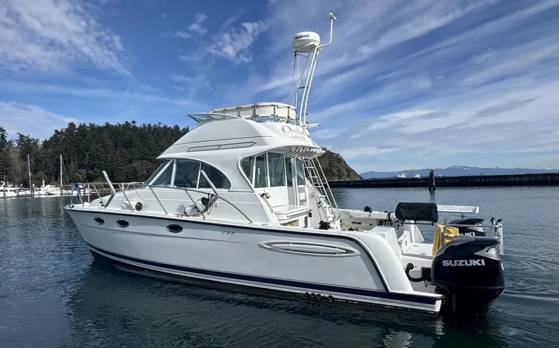 Slide: The Image of 2005 Glacier Bay 3490 Ocean Runner boat on calm water, featuring Suzuki outboard motor. - 6