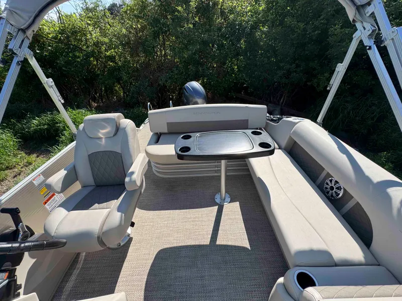 Slide: The Image of 2018 Bennington SX 22 SSBXP pontoon boat interior with seating and table. - 10