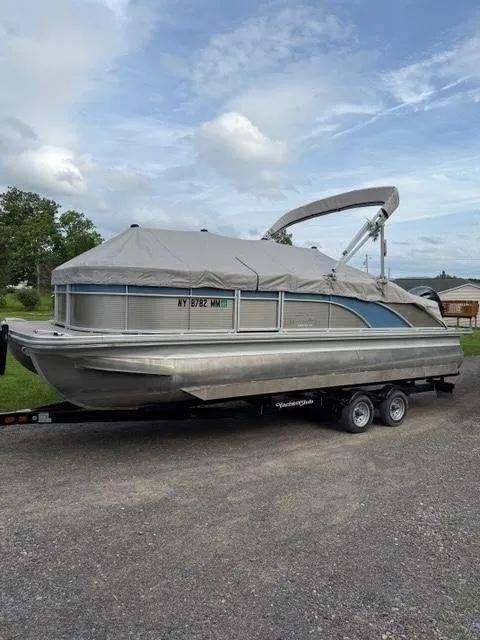 Slide: The Image of 2018 Bennington SX 22 SSBXP pontoon boat on trailer, covered, parked outdoors. - 12