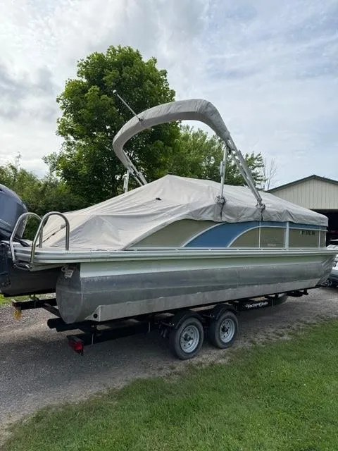 Slide: The Image of 2018 Bennington SX 22 SSBXP pontoon boat on trailer with cover, parked outdoors. - 13