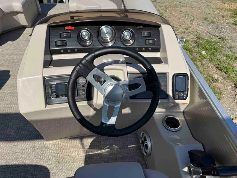 Slide: The Image of 2018 Bennington SX 22 SSBXP boat dashboard with steering wheel and controls. - 18