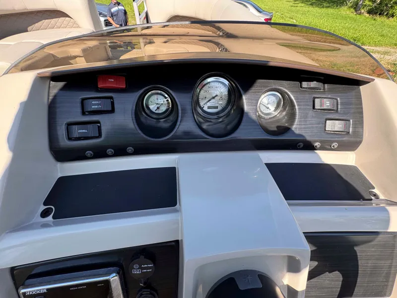 Slide: The Image of 2018 Bennington SX 22 SSBXP dashboard with gauges and controls in a boat cockpit. - 22