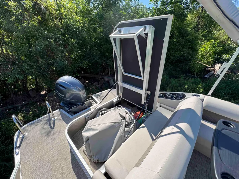 Slide: The Image of 2018 Bennington SX 22 SSBXP pontoon boat with Yamaha motor, open storage compartment. - 24