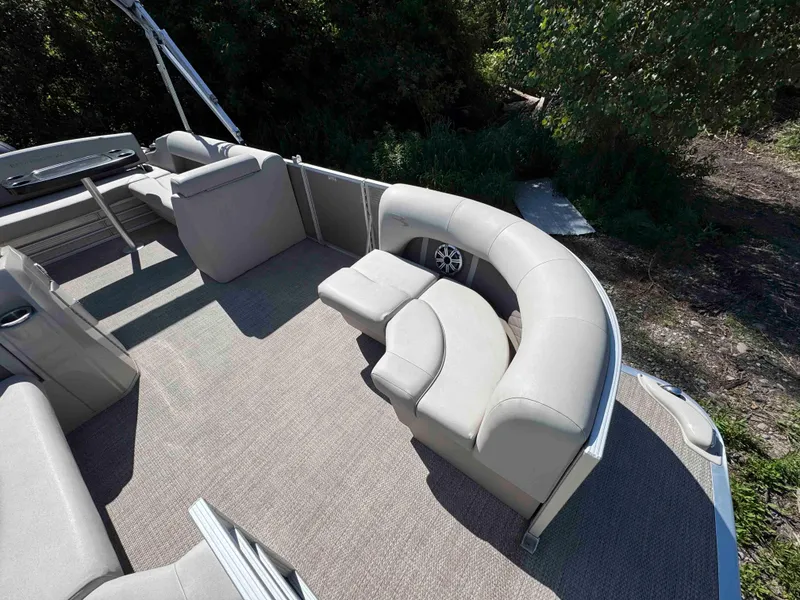 Slide: The Image of 2018 Bennington SX 22 SSBXP pontoon boat with spacious seating and lush greenery backdrop. - 6