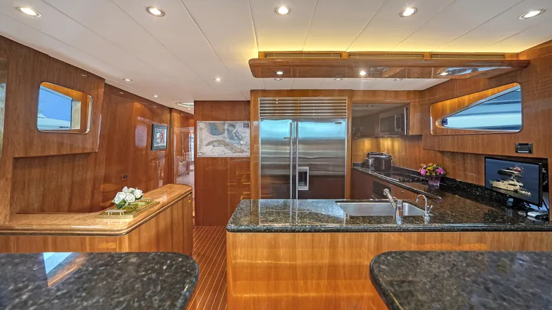 Slide: The Image of Luxurious kitchen interior of 2007 Horizon 95 yacht with wood finishes and modern appliances. - 22