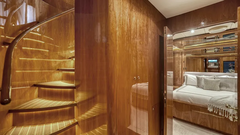 Slide: The Image of Luxurious wooden staircase and bedroom interior on a 2007 Horizon 95 yacht. - 23