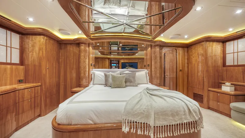 Slide: The Image of Luxurious wooden interior of a 2007 Horizon 95 yacht bedroom with elegant bedding. - 24