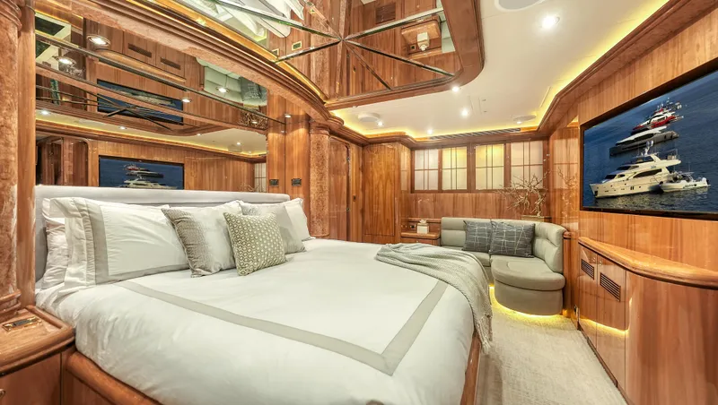 Slide: The Image of Luxurious 2007 Horizon 95 yacht bedroom with elegant wood paneling and modern decor. - 25