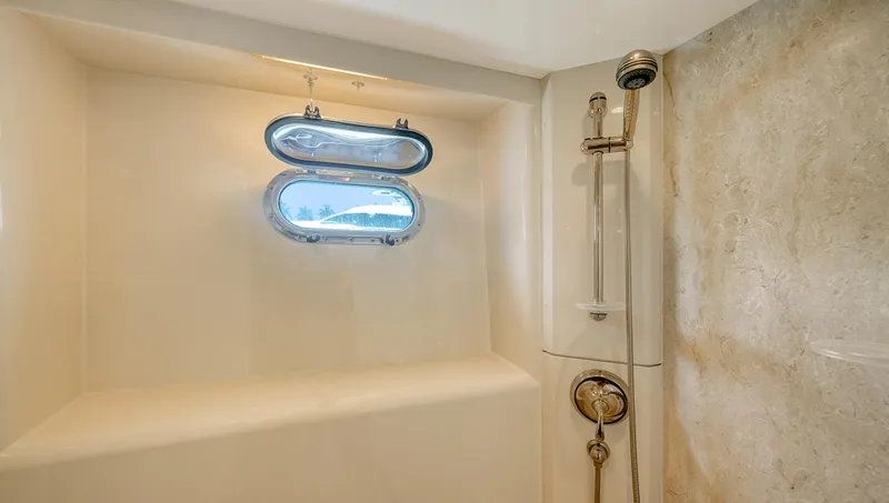 Slide: The Image of Shower area in 2007 Horizon 95 yacht with porthole window and modern fixtures. - 30
