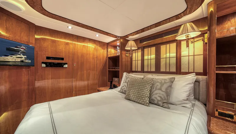 Slide: The Image of Luxurious bedroom interior of 2007 Horizon 95 yacht with elegant wood paneling and ambient lighting. - 35