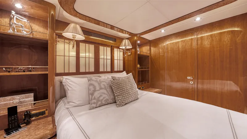 Slide: The Image of Luxurious bedroom interior on 2007 Horizon 95 yacht, featuring elegant wood paneling and cozy bedding. - 36